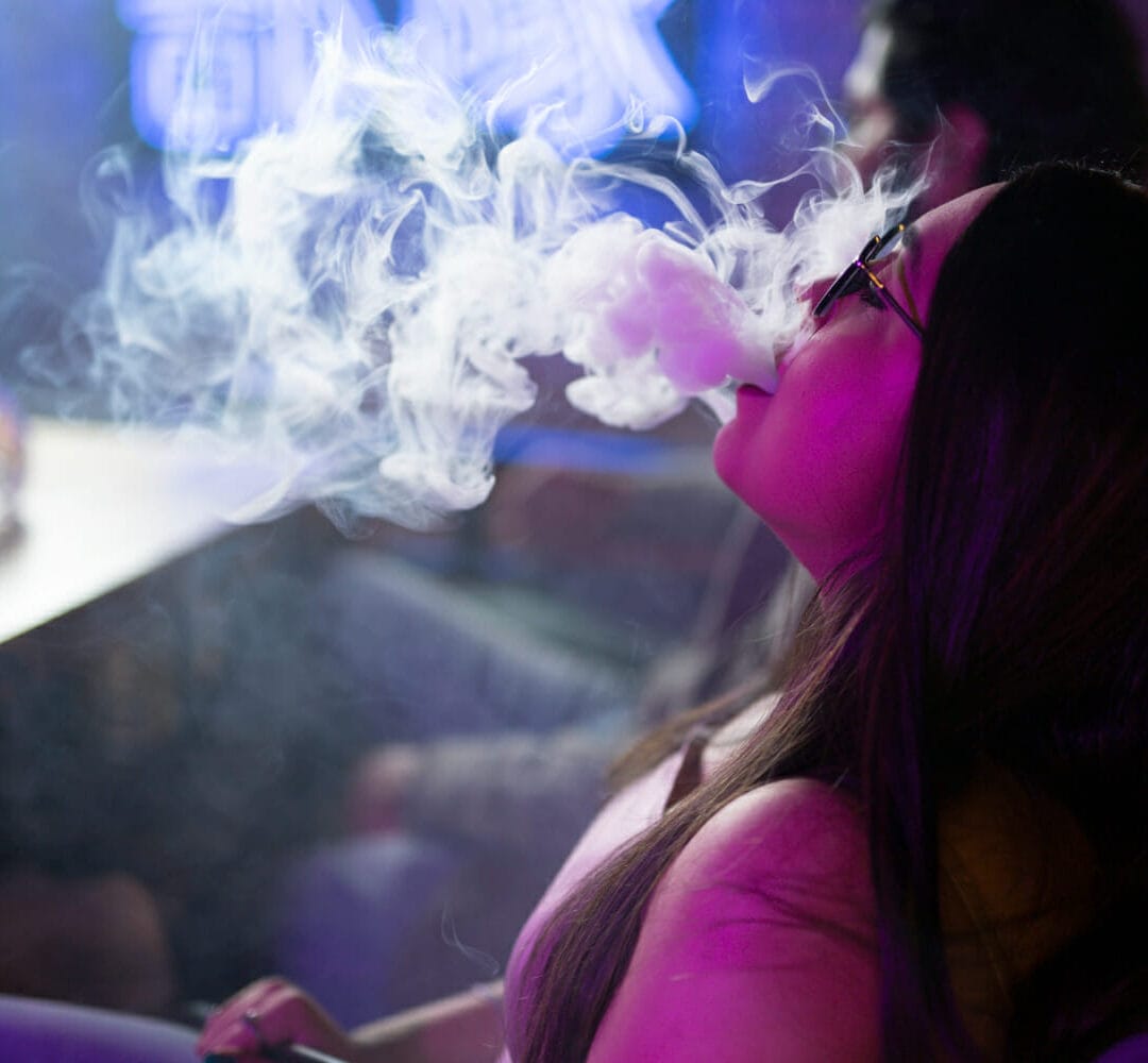 woman-relaxing-by-vaping-from-hookah-bar